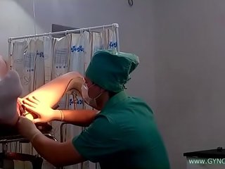 A young young lady in putih kasut on a gynecological chair