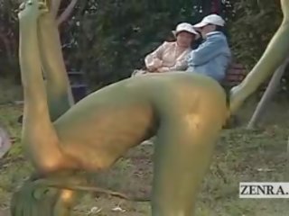 Subtitled ýapon woman painted to mimic park statue